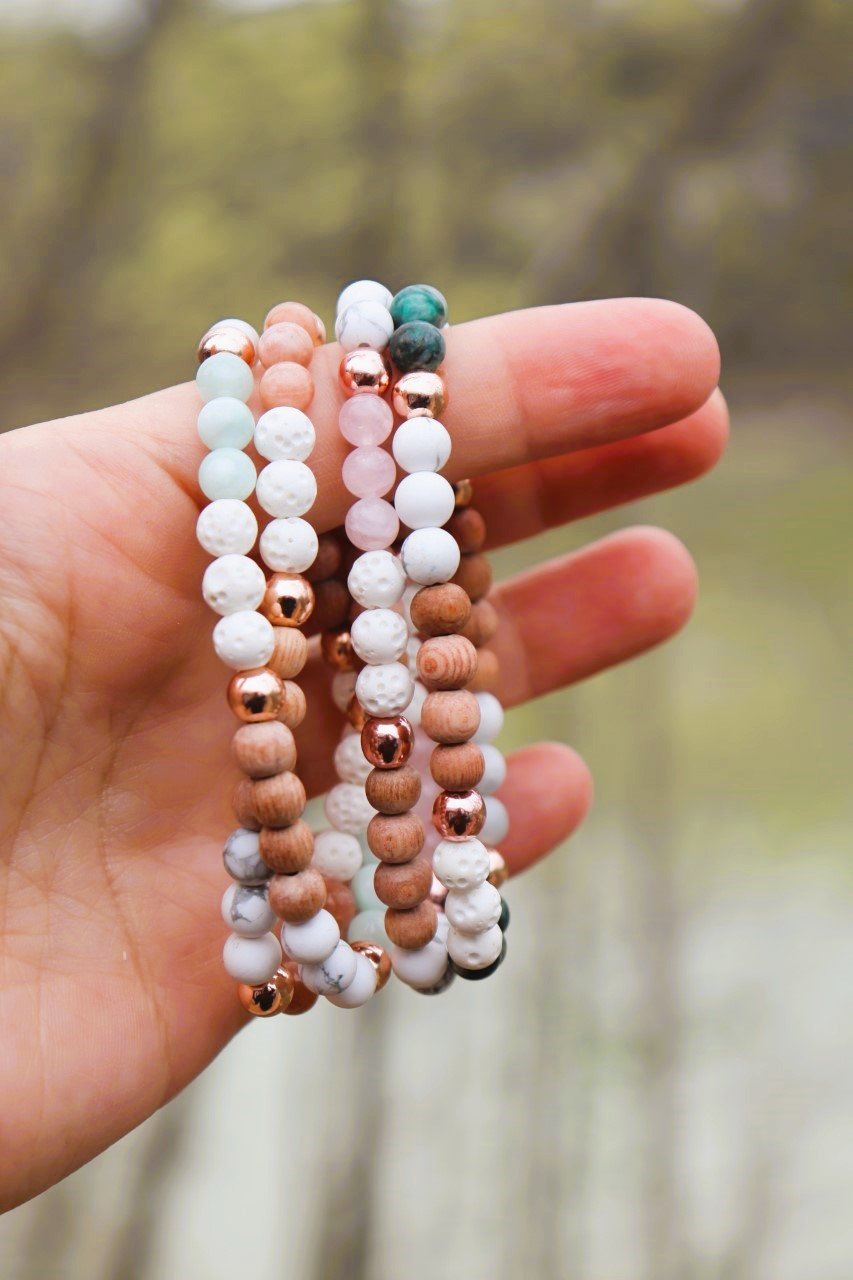 hand holding multiple diffuser bracelets