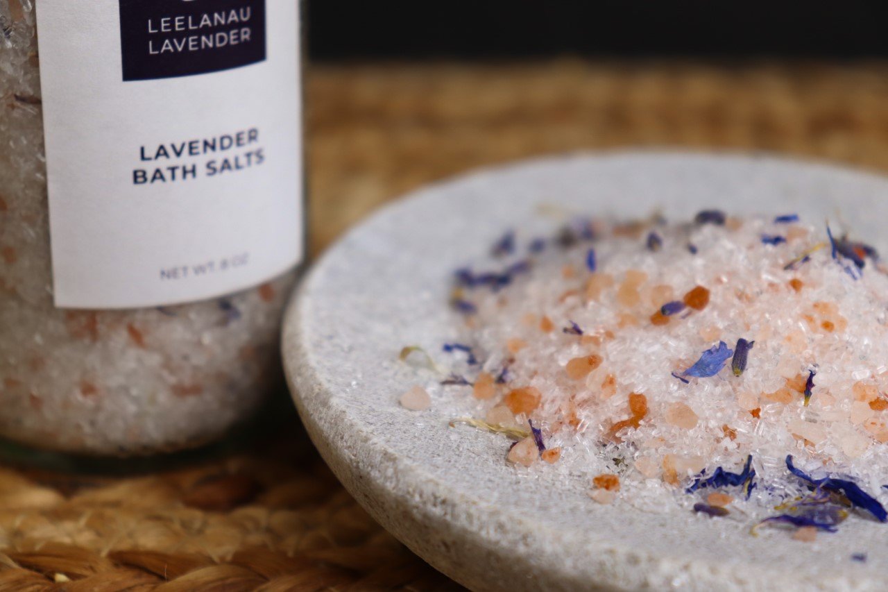 A pile of bath salts with pink sea salt and cornflower petals