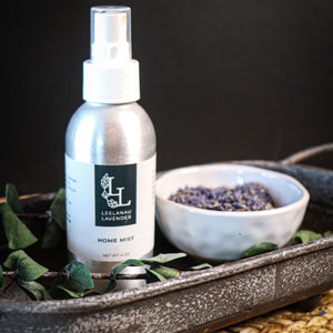 Lavender home spray with a bowl of lavender buds